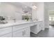 Elegant bathroom featuring dual sinks, granite countertops, and modern fixtures at 3777 Sw 130Th Loop, Ocala, FL 34473
