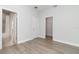 Neutral bedroom boasts a walk-in closet and attached bathroom with wood-look floors at 3777 Sw 130Th Loop, Ocala, FL 34473