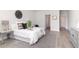 Inviting bedroom featuring a queen-sized bed, soft rug, and simple decor at 3777 Sw 130Th Loop, Ocala, FL 34473