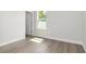 Bright bedroom with light wood floors, a white door, and a window at 3777 Sw 130Th Loop, Ocala, FL 34473
