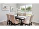 Bright dining room with a rustic table, seating for six, and a large window at 3777 Sw 130Th Loop, Ocala, FL 34473