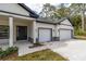 Close-up of the house's entrance and garage, showcasing the fresh landscaping at 3777 Sw 130Th Loop, Ocala, FL 34473
