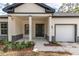 The house's entrance has columns and some beautiful decorative shrubbery at 3777 Sw 130Th Loop, Ocala, FL 34473