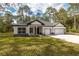Lovely exterior shot of a single-story home with a well-maintained lawn and two-car garage at 3777 Sw 130Th Loop, Ocala, FL 34473