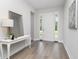 Bright, airy foyer with hardwood floors, white walls and a decorative table at 3777 Sw 130Th Loop, Ocala, FL 34473