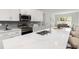 Spacious kitchen with an island, quartz countertops, and stainless steel appliances at 3777 Sw 130Th Loop, Ocala, FL 34473
