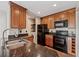 Well-equipped kitchen with dark countertops, wooden cabinets, and modern appliances, creating an efficient cooking space at 390 Lake Placid Ct # 304, Altamonte Springs, FL 32701