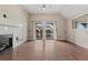 Open living room featuring hardwood floors, a fireplace, and sliding doors to a balcony, perfect for relaxing at 390 Lake Placid Ct # 304, Altamonte Springs, FL 32701