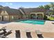Community pool surrounded by a brick paver deck and chaise lounges providing ample room for sunning at 390 Lake Placid Ct # 304, Altamonte Springs, FL 32701