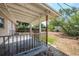 Covered back porch with a wood railing at 4124 Caywood Cir, Orlando, FL 32810