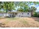 A home's backyard featuring a covered patio and lush green space at 4124 Caywood Cir, Orlando, FL 32810