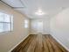 Bedroom with modern vinyl floors, neutral walls, and natural light from two windows at 4124 Caywood Cir, Orlando, FL 32810