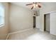 Bedroom showcasing a ceiling fan, tile flooring, closet and neutral paint, ready for your personal touch at 4124 Caywood Cir, Orlando, FL 32810