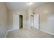 A neutral bedroom features tile floors, a closet, and easy access to the en-suite bathroom at 4124 Caywood Cir, Orlando, FL 32810