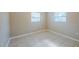 This bedroom features tile flooring and two windows creating a bright and airy atmosphere at 4124 Caywood Cir, Orlando, FL 32810