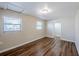 Bedroom with modern vinyl floors, neutral walls, and natural light from two windows at 4124 Caywood Cir, Orlando, FL 32810