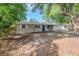 Charming single-story home featuring a cozy covered porch and well-manicured landscaping in the front yard at 4124 Caywood Cir, Orlando, FL 32810