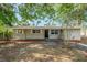 Charming single-story home with a dark front door and well-manicured landscaping in the front yard at 4124 Caywood Cir, Orlando, FL 32810