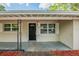Welcoming front porch featuring a dark front door with sidelights and a covered entryway at 4124 Caywood Cir, Orlando, FL 32810