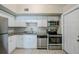 Bright kitchen featuring stainless steel appliances, white cabinets, and granite countertops at 4124 Caywood Cir, Orlando, FL 32810
