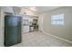 Well-equipped kitchen featuring modern appliances, white cabinets, and tiled flooring at 4124 Caywood Cir, Orlando, FL 32810