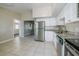 Bright kitchen featuring stainless steel appliances, white cabinets, and granite countertops at 4124 Caywood Cir, Orlando, FL 32810