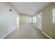 Spacious living room featuring neutral paint, tiled floors, and a bright front door at 4124 Caywood Cir, Orlando, FL 32810