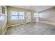 Bright and airy living room featuring neutral walls, tile flooring, and plenty of natural light at 4124 Caywood Cir, Orlando, FL 32810