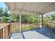 Covered patio with a wooden railing overlooks the backyard at 4124 Caywood Cir, Orlando, FL 32810