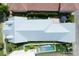 A bird's eye view reveals a silver roof, a backyard pool, an outdoor dining area and manicured landscaping at 4148 Oak St, Orlando, FL 32814