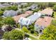Aerial view of a charming light grey home with meticulously maintained landscaping and beautiful roof at 4148 Oak St, Orlando, FL 32814