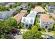 Overhead view of a light grey home with dormer windows, complemented by lush greenery and a serene neighborhood setting at 4148 Oak St, Orlando, FL 32814