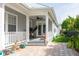 Covered porch with outdoor seating and view of fenced yard at 4148 Oak St, Orlando, FL 32814