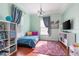 Cozy bedroom with natural light, hardwood floors, a bed, and modern decor, creating a comfortable space at 4148 Oak St, Orlando, FL 32814