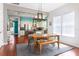 This expansive dining area features a wooden table, bench, and seamlessly connects to the modern kitchen at 4148 Oak St, Orlando, FL 32814