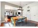 This open-concept dining space flows into the living room, and features a rustic light fixture and wooden table with seating at 4148 Oak St, Orlando, FL 32814