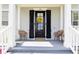 Inviting front porch with seating, a decorative wreath, and a stylish front door, creating a warm welcome at 4148 Oak St, Orlando, FL 32814