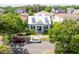 Charming grey home with dormer windows and a welcoming front porch, framed by mature trees and manicured landscaping at 4148 Oak St, Orlando, FL 32814