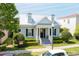 A charming home with dormer windows, a black front door with a yellow wreath, and beautiful landscaping at 4148 Oak St, Orlando, FL 32814