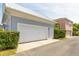 Detached two-car garage with white doors and manicured landscaping at 4148 Oak St, Orlando, FL 32814