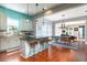 Open kitchen features granite countertops, a breakfast bar with seating, and seamlessly connects to the dining and living areas at 4148 Oak St, Orlando, FL 32814