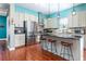 Modern kitchen featuring stainless steel appliances, a kitchen island with seating, and stylish lighting, perfect for cooking at 4148 Oak St, Orlando, FL 32814