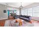 Inviting living room boasts a large sectional, wood floors, and is open to the dining area and kitchen at 4148 Oak St, Orlando, FL 32814