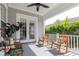 Covered patio with rocking chairs and view of a lush backyard at 4148 Oak St, Orlando, FL 32814