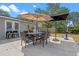 Outdoor dining on back patio with table, chairs, and umbrellas; perfect for relaxing with Gathering and friends at 424 Eden Park Rd, Altamonte Springs, FL 32714