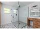 Bright bathroom with geometric tile floors, frameless shower and modern wood vanity at 424 Eden Park Rd, Altamonte Springs, FL 32714