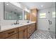 Well-lit bathroom featuring a double vanity, stylish tile flooring, and modern fixtures at 424 Eden Park Rd, Altamonte Springs, FL 32714