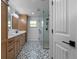 Modern bathroom features a double sink vanity, striking floor tiles, and frameless shower at 424 Eden Park Rd, Altamonte Springs, FL 32714