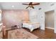 Bright bedroom featuring wood floors, a queen bed, and a floral accent wall at 424 Eden Park Rd, Altamonte Springs, FL 32714