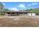 Charming exterior of home features a covered porch and a two-car garage at 424 Eden Park Rd, Altamonte Springs, FL 32714